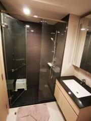 Modern bathroom with glass shower and wooden vanity