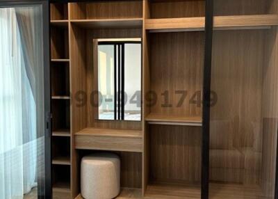 Modern bedroom with built-in wooden shelving and efficient air conditioning