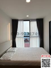 Bright bedroom with a large window and city view