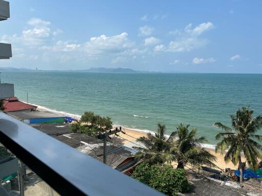 Scenic ocean view from the balcony with clear sky and beachfront