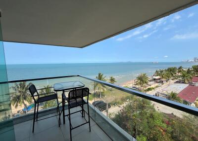 Spacious balcony overlooking the sea with outdoor seating