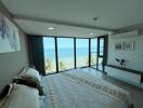Ocean view bedroom with large windows and modern decor