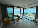Bright and modern living room with ocean view and balcony access