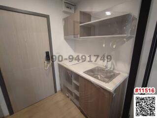 Modern compact kitchen with stainless steel sink and wooden flooring