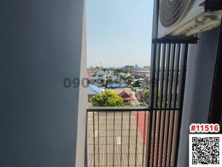 View from balcony showing urban landscape and safety grilling