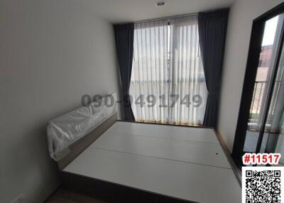 Minimalist bedroom with large window and natural light