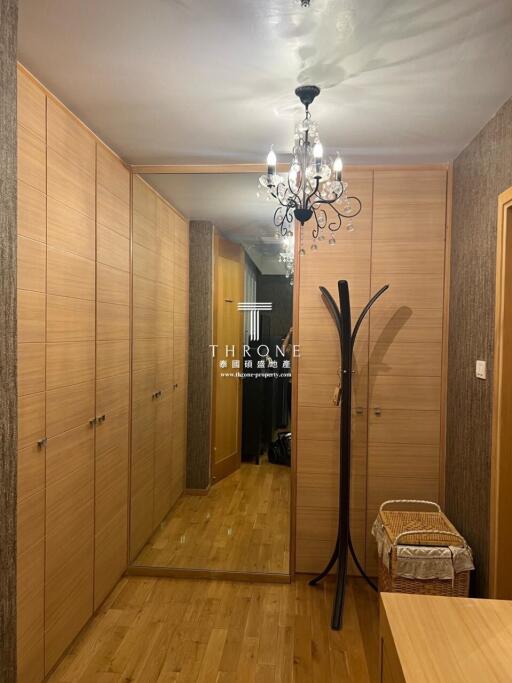 Elegant hallway interior with wooden wardrobes and decorative chandelier