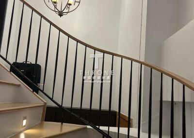 Elegant staircase with modern lighting in a well-lit home interior
