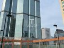 Modern skyscraper with tennis court in the foreground in urban area