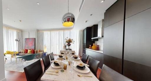 Elegant modern dining room with adjacent kitchen area