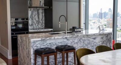 Modern kitchen with marble countertops and city skyline view