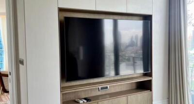 Modern living room with large television and city view