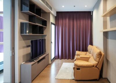 Modern living room with elegant furniture and plush purple curtains