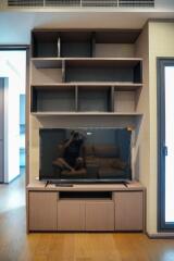 Modern living room with large TV and custom shelving