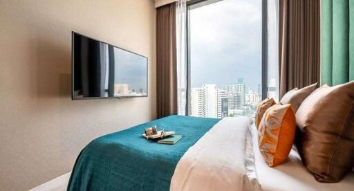 Modern bedroom with city view and mounted television