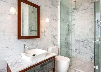 Modern bathroom with marble walls and glass shower