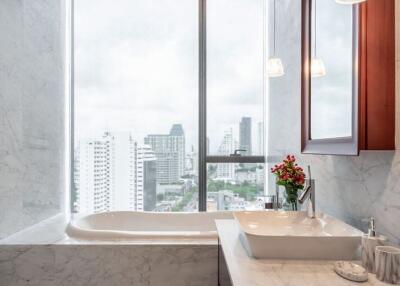 Elegant bathroom with marble finishes and city view