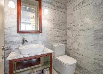 Elegant bathroom with marble walls and sophisticated fixtures