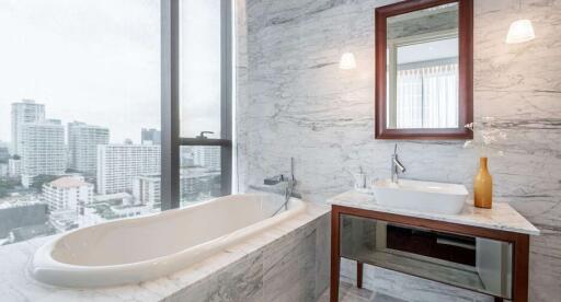 Modern bathroom with large windows overlooking the city