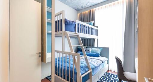 Compact modern bedroom with bunk beds, bright decor, and elegant furnishings