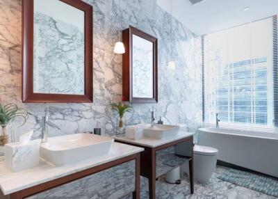 Elegant modern bathroom with marble walls and dual sinks