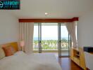 Bright and spacious bedroom with ocean view through glass doors