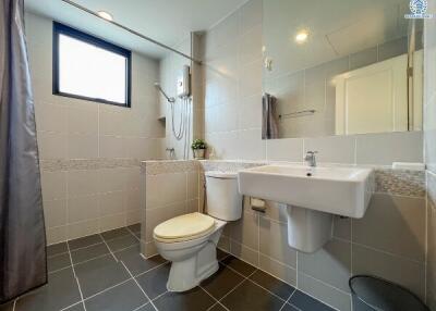 Modern bathroom with tiled flooring and neutral color palette