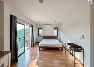 Spacious bedroom with large bed and balcony access