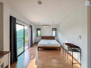 Spacious bedroom with large bed and balcony access