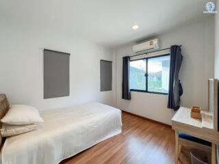 Bright and airy minimalist bedroom with large window