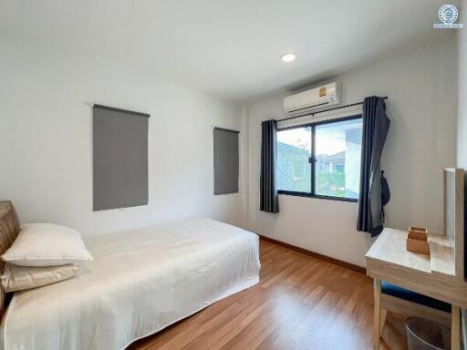 Bright and airy minimalist bedroom with large window