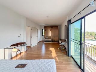 Spacious bedroom with large glass windows and modern furnishings