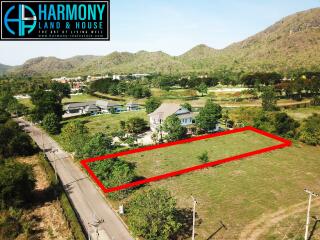 Aerial view of a single-family house with large yard and surrounding mountain landscape