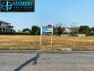 For Sale land plot by Harmony Land & House with a sign on a sunny day