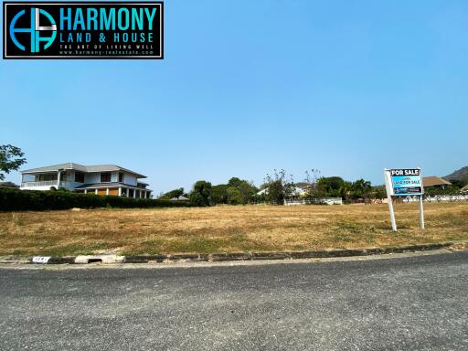 Spacious property for sale with large front yard and a single house in the background