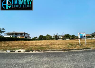 Spacious property for sale with large front yard and a single house in the background