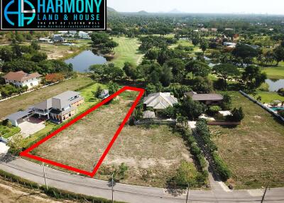 Aerial view of a spacious property plot marked for sale in a suburban area with green background