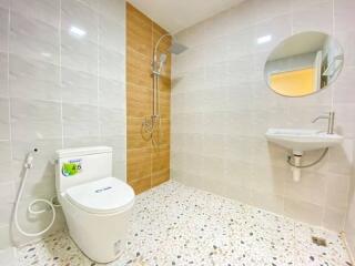 Modern bathroom with shower, toilet, and sink