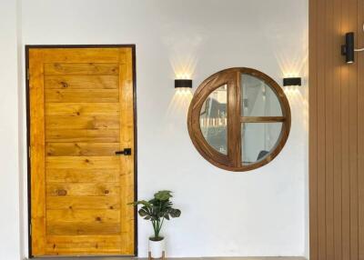 Stylish entryway with wooden door and circular window