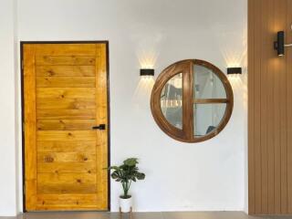 Stylish entryway with wooden door and circular window
