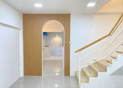 Bright and modern hallway leading to a stylish kitchen