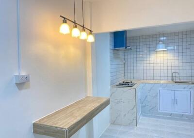 Modern kitchen with breakfast bar and stylish lighting