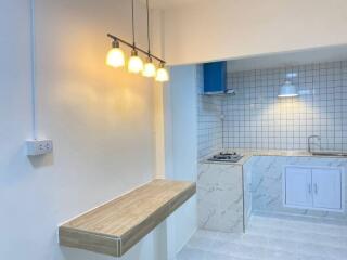 Modern kitchen with breakfast bar and stylish lighting