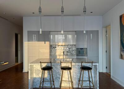Modern kitchen with marble island and stylish pendant lights