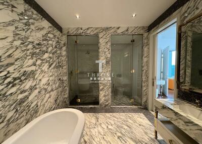 Luxurious marble bathroom with freestanding tub and glass shower enclosure