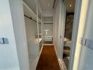 Modern corridor view showing built-in storage cabinets and stylish flooring