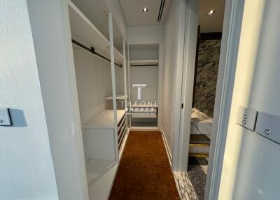 Modern corridor view showing built-in storage cabinets and stylish flooring