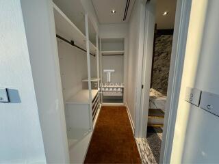 Modern corridor view showing built-in storage cabinets and stylish flooring