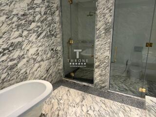 Luxurious marble bathroom with freestanding tub and separate shower