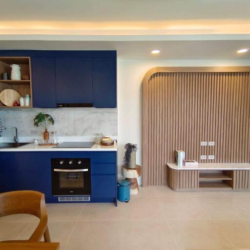 Modern kitchen with blue cabinets and integrated appliances